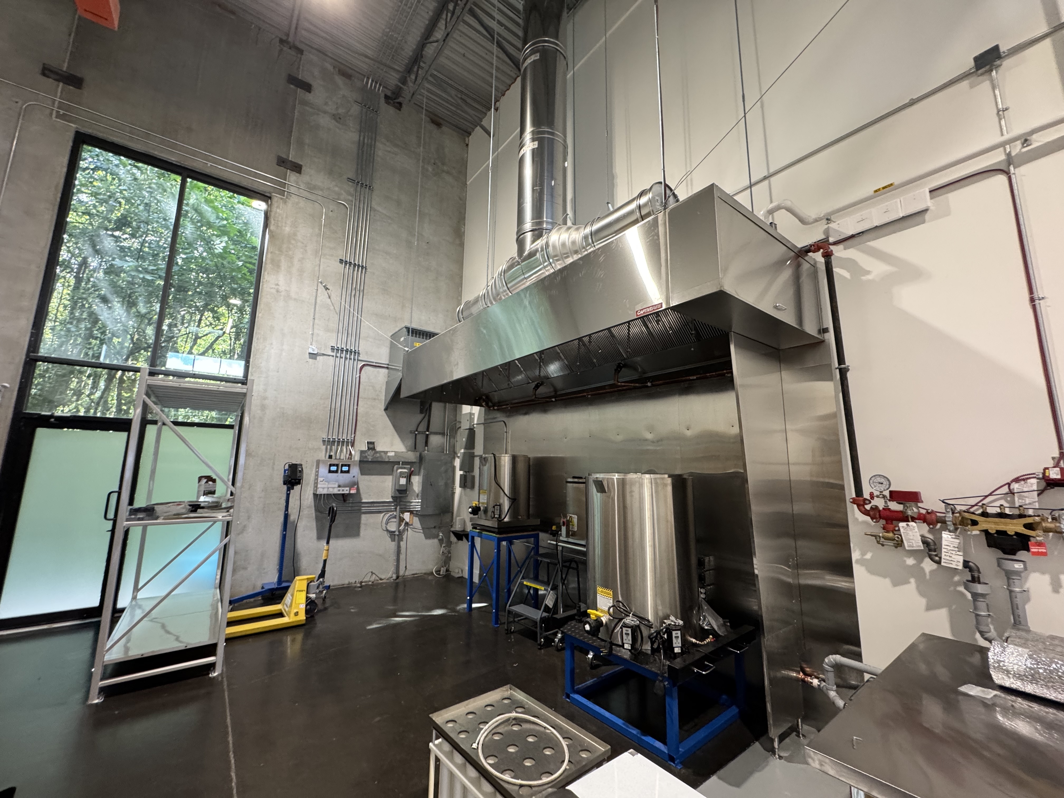 Aabluo soap factory build-out with industrial machinery and fire suppression systems.